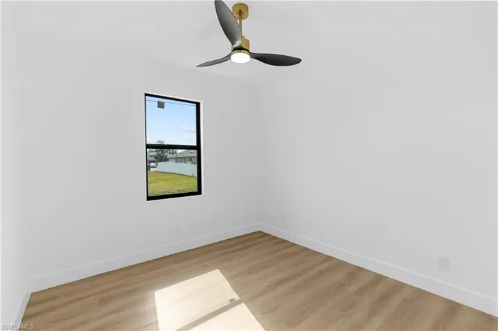 Spare room featuring light wood finished floors and ceiling fan