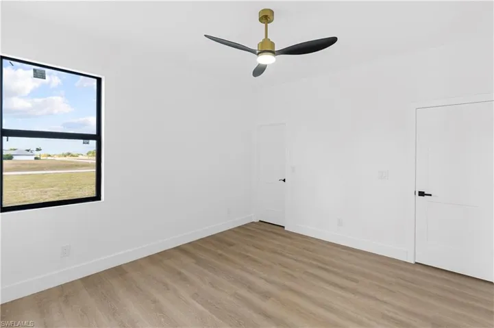 Unfurnished bedroom featuring light wood finished floors and ceiling fan