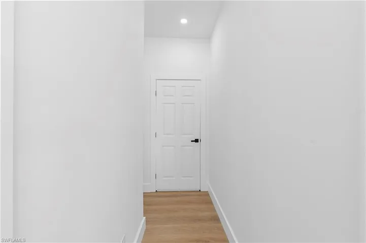 Hallway featuring light wood-style flooring and recessed lighting
