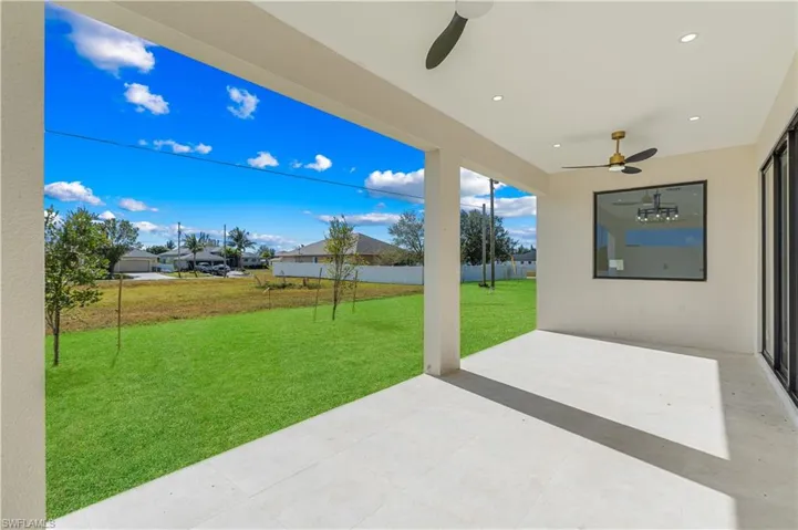 View of patio featuring a ceiling fan and a residential view