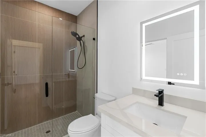 Full bath with a stall shower and vanity