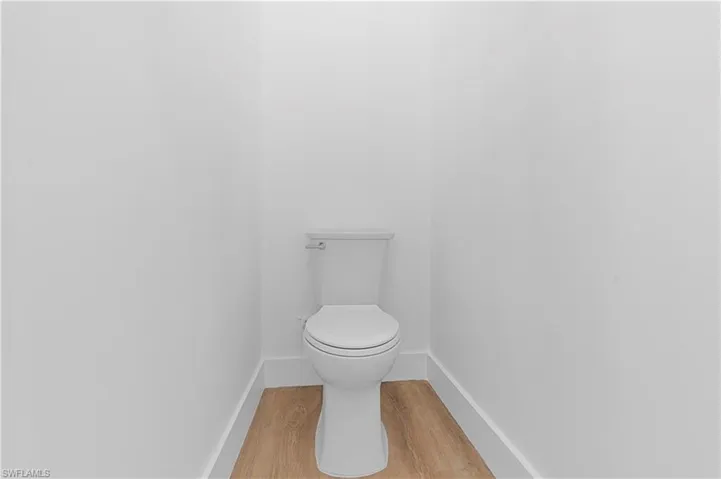 Bathroom with wood finished floors and baseboards