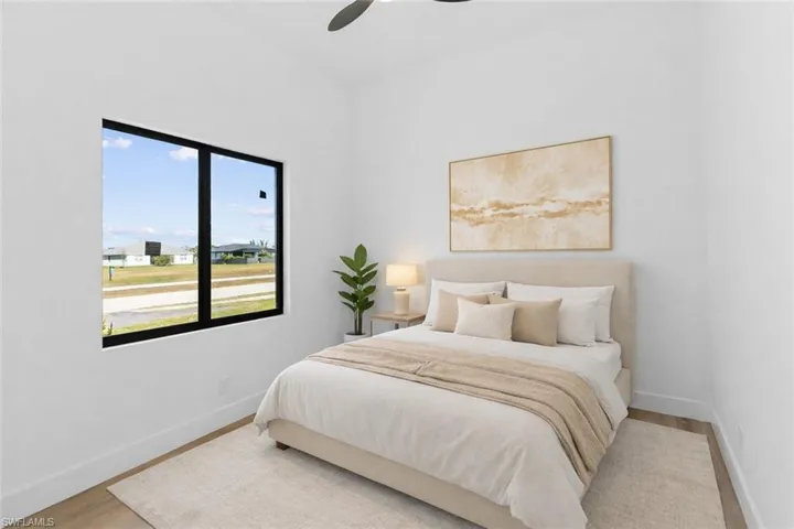 Bedroom with a ceiling fan and wood finished floors