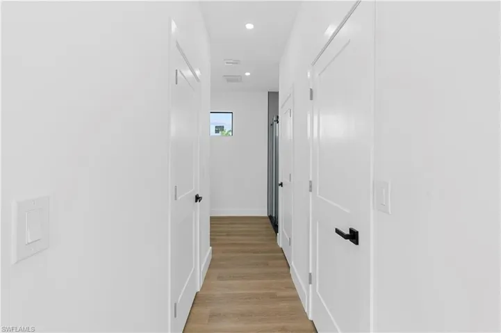 Hall featuring recessed lighting and light wood-style floors