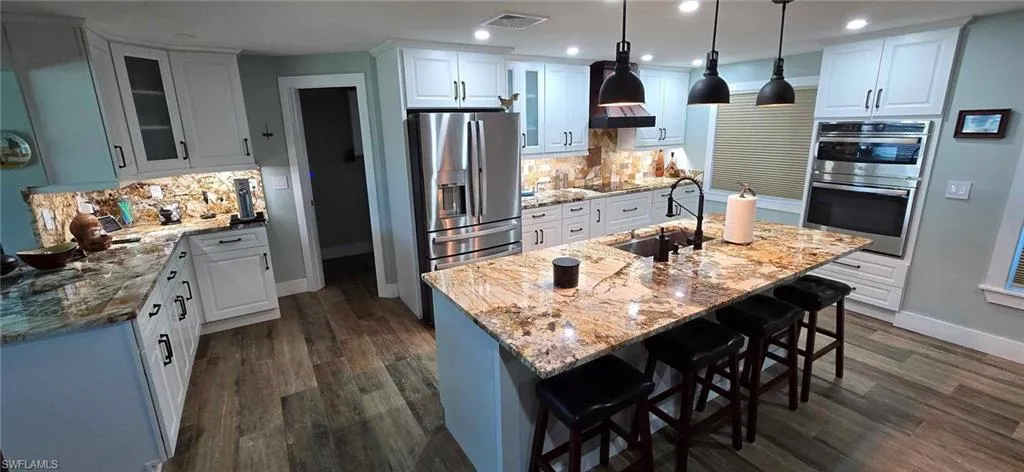 Kitchen featuring stainless steel appliances, visible vents, a sink, and white cabinetry