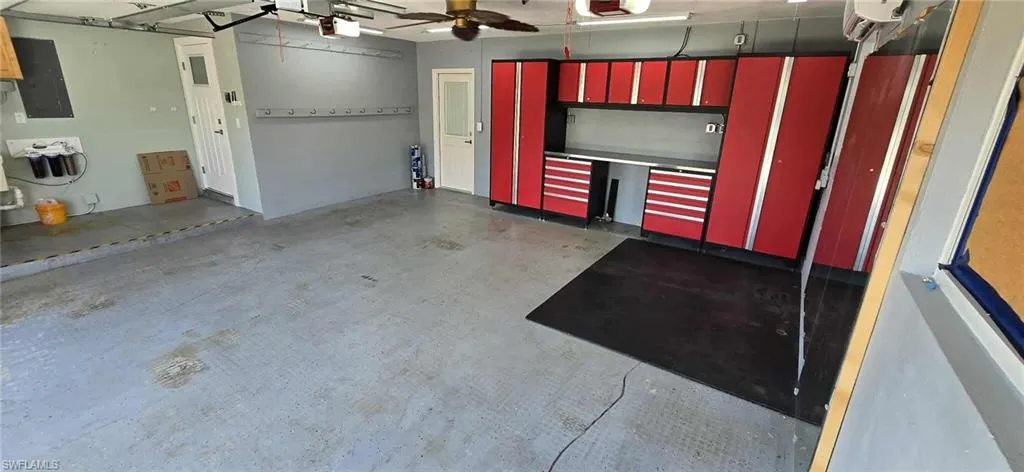 Garage featuring electric panel and a garage door opener