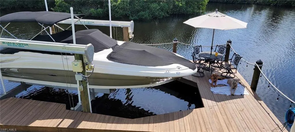 Dock area with a water view and boat lift