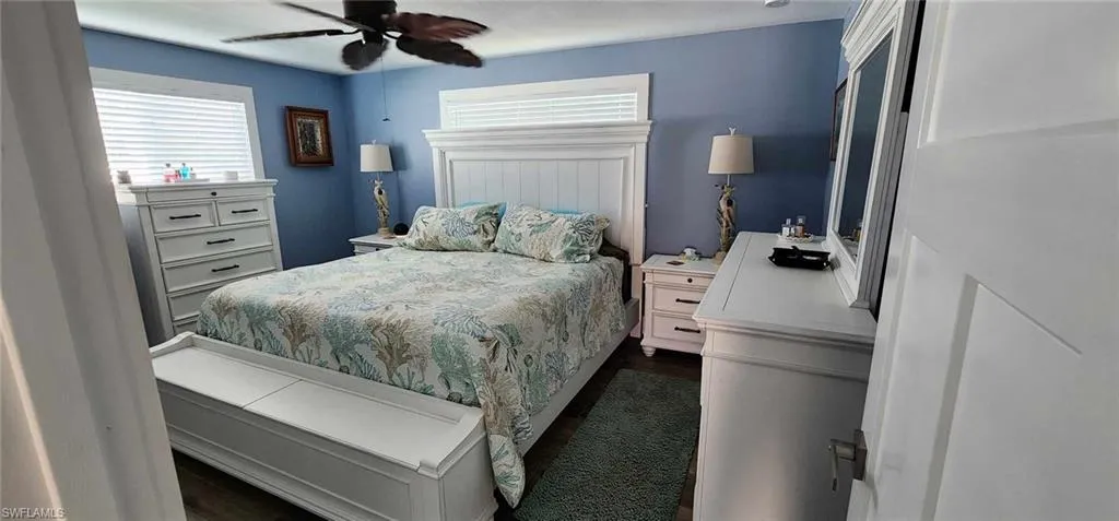 Bedroom with ceiling fan and dark wood finished floors