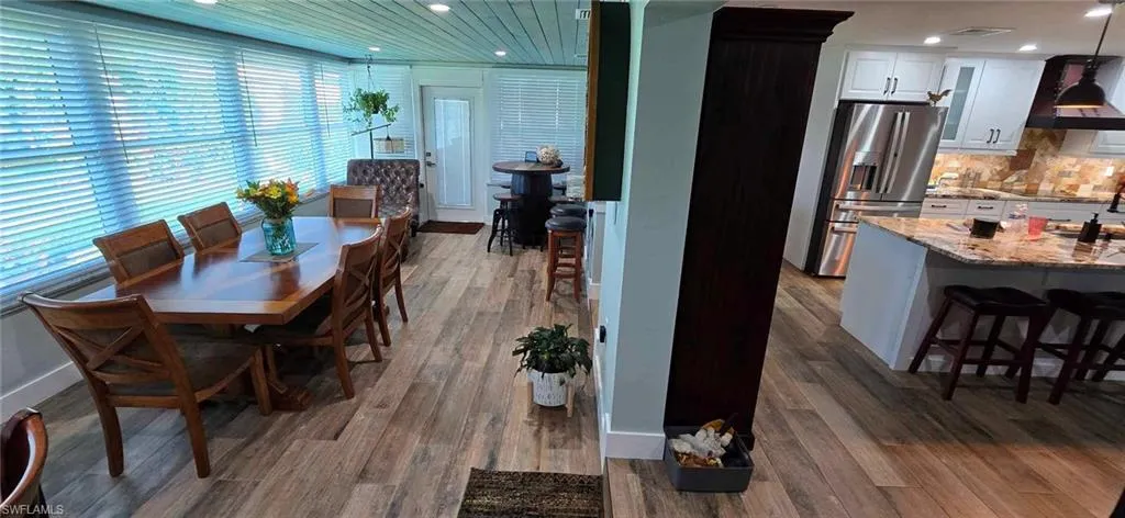 Dining space featuring baseboards, wood finished floors, and recessed lighting