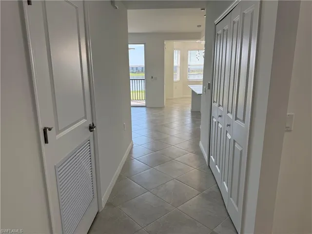 Hallway to living room, dining area, and kitchen