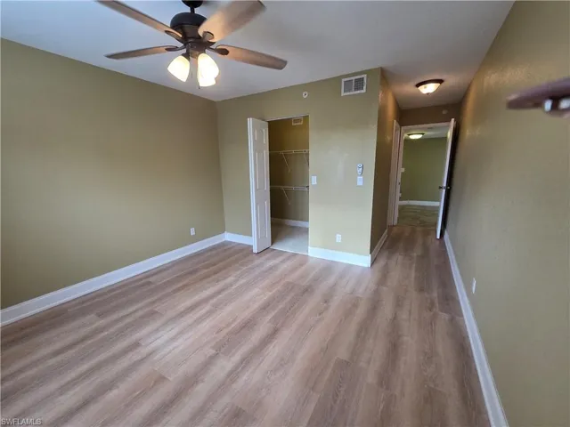 Unfurnished bedroom featuring ceiling fan, light wood-type flooring, and a closet