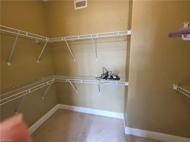 Walk in closet featuring carpet