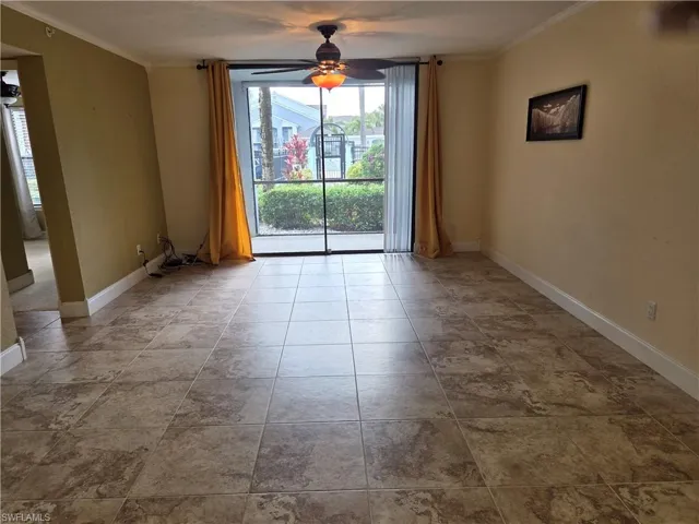 Unfurnished room featuring ceiling fan and crown molding