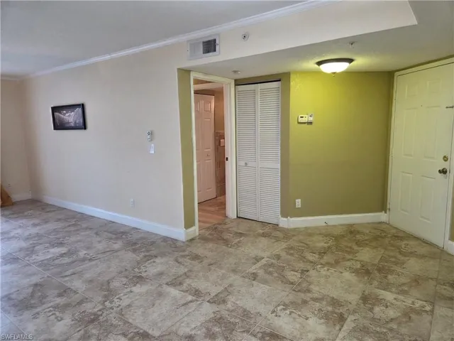 Unfurnished room featuring baseboards and ornamental molding
