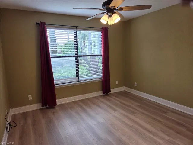 Unfurnished room featuring ceiling fan and wood finished floors