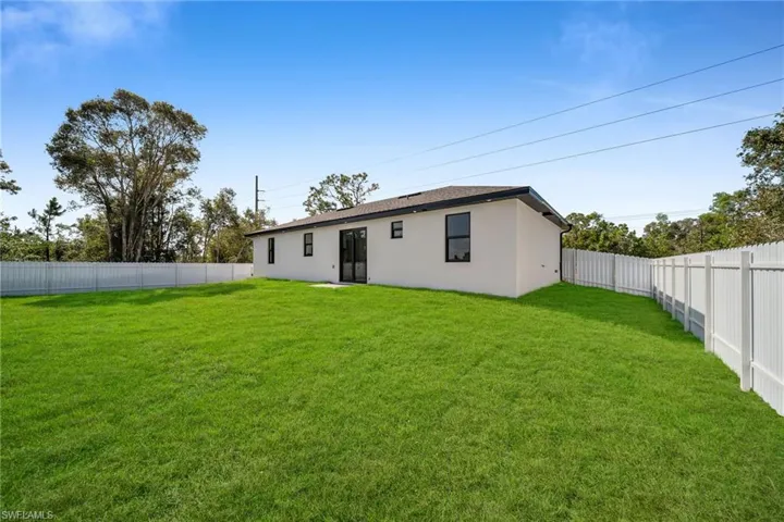 Back of house featuring a lawn