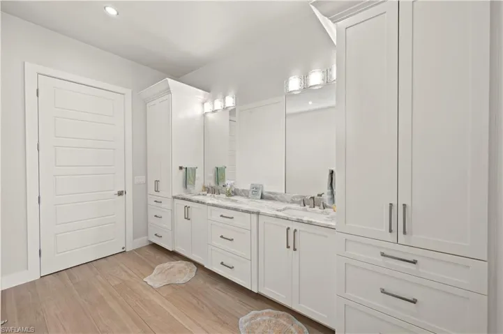 Dual vanity with undermount sinks and light-toned stone countertops