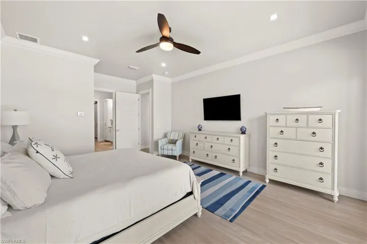 Spacious interior room featuring light-toned flooring and recessed lighting