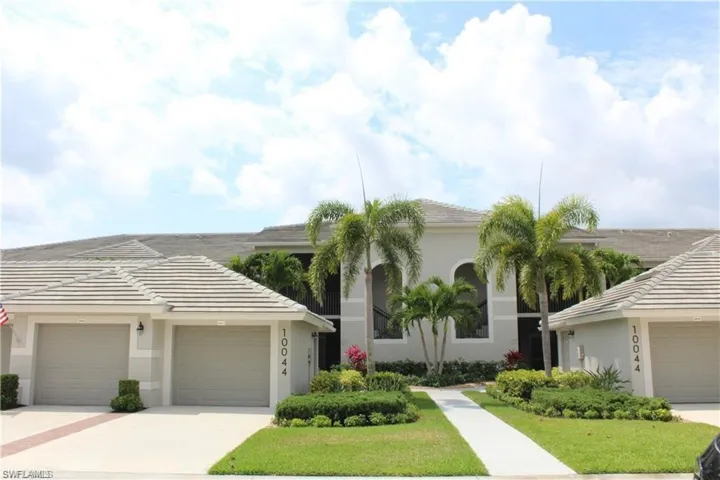 View of front of home featuring a garage and a front lawn