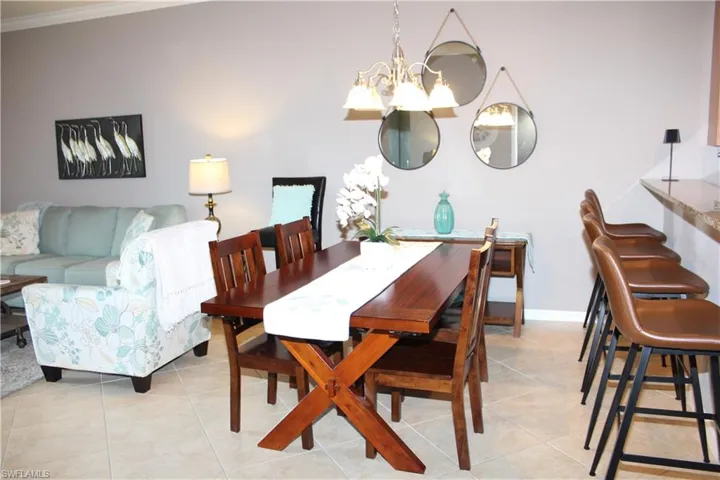 Dining space featuring suspended lighting and light tile patterned floors