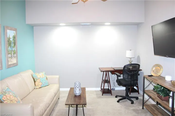Home office with carpet floors and ceiling fan