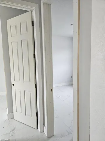 Corridor with tile patterned flooring