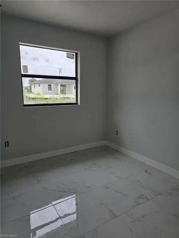 Empty room featuring light tile patterned floors