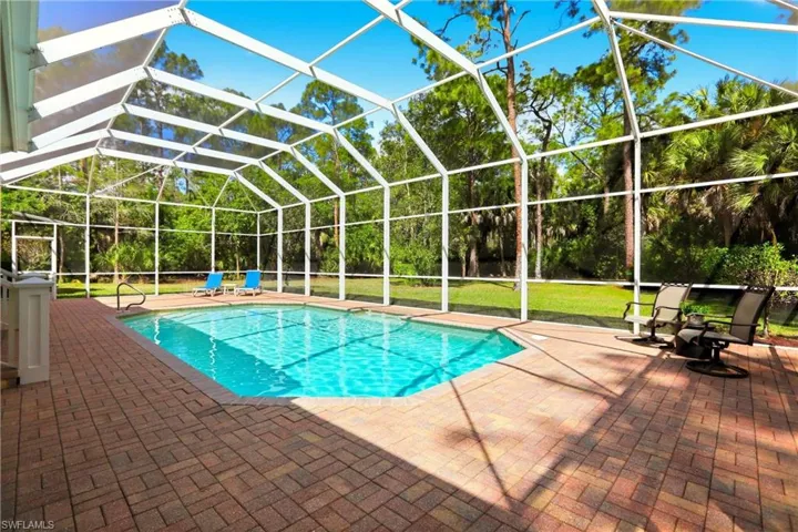 Outdoor pool with a lanai, a sunroom, and a patio area