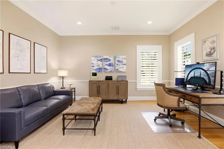 Office area with light wood-type flooring, ornamental molding, and recessed lighting