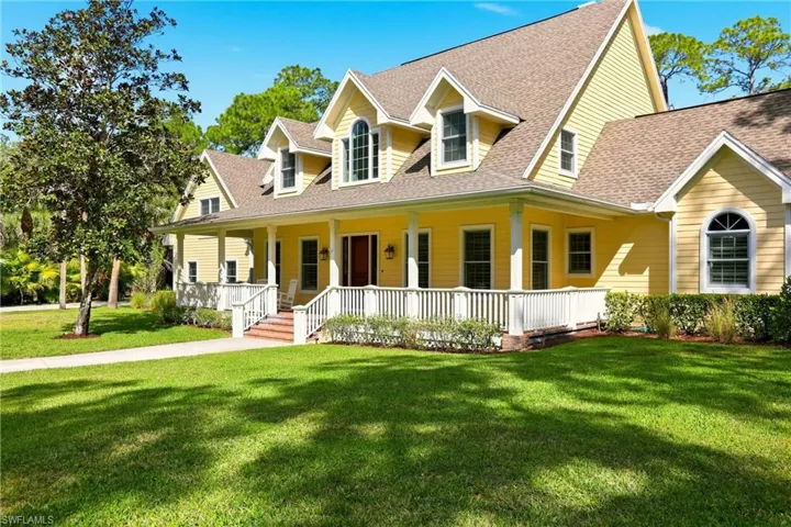Cape cod house featuring covered porch, a front yard, and roof with shingles