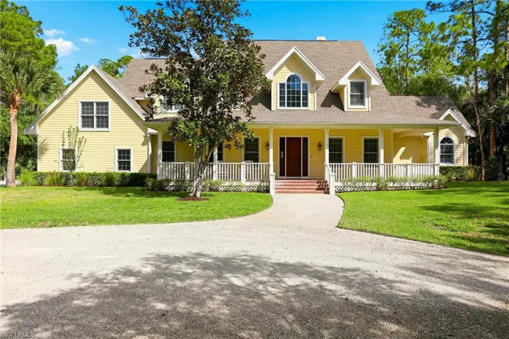 Cape cod house featuring a porch, roof with shingles, and a front yard