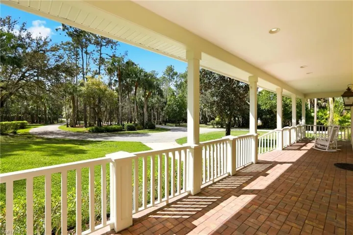 Wooden porch with a lawn
