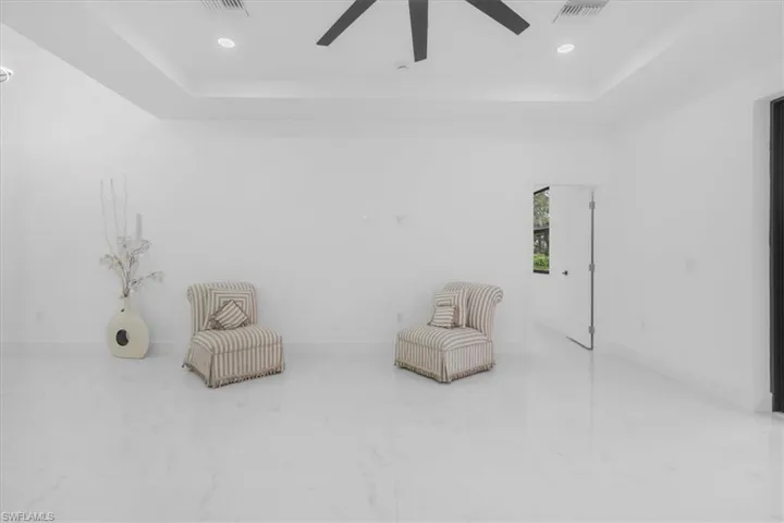 Unfurnished room with a tray ceiling, recessed lighting, and ceiling fan