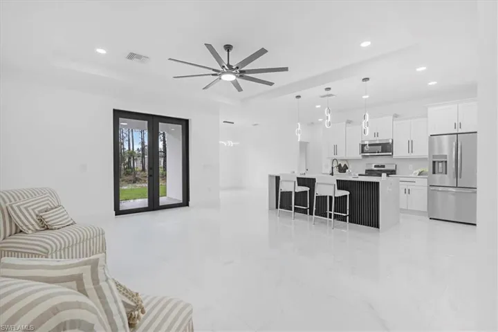 Living area featuring recessed lighting, french doors, and ceiling fan