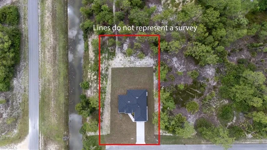 Aerial view of property and surrounding area featuring property parcel outlined