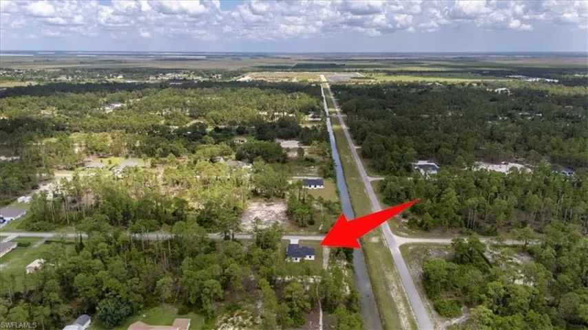 View of property location featuring a forest