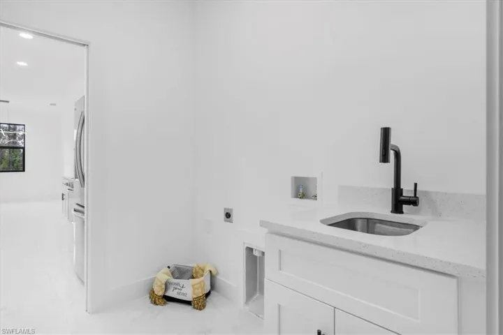 Laundry area with recessed lighting, washer hookup, hookup for an electric dryer, and cabinet space