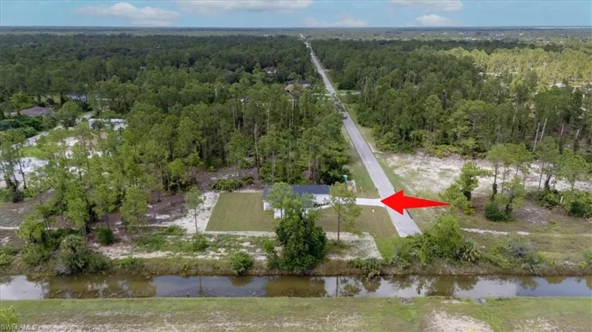 Aerial view of property's location featuring a large body of water