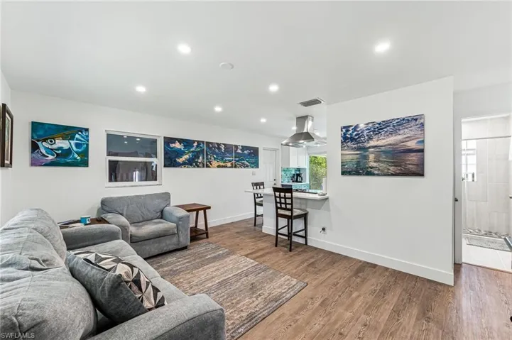 Living room with hardwood / wood-style flooring