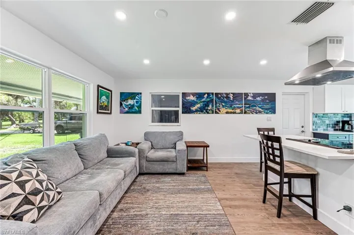 Living room with light hardwood / wood-style floors