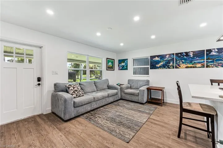 Living room featuring hardwood / wood-style flooring and a healthy amount of sunlight