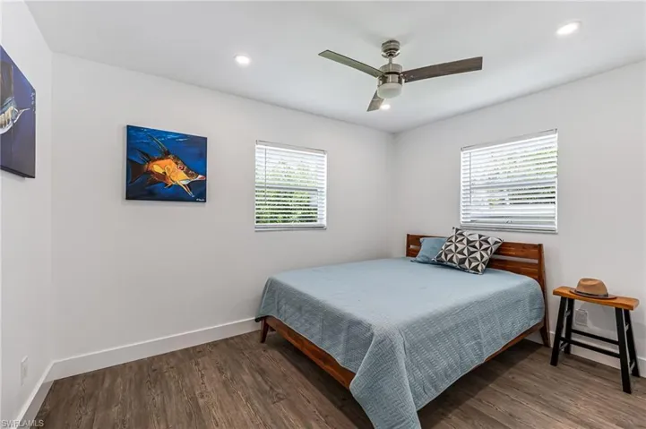 Bedroom with dark wood-type flooring and ceiling fan