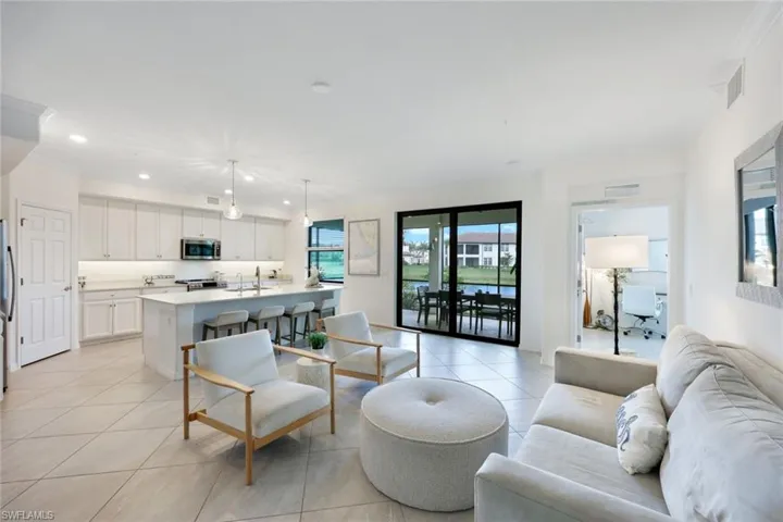 Living room featuring light tile patterned floors and recessed lighting