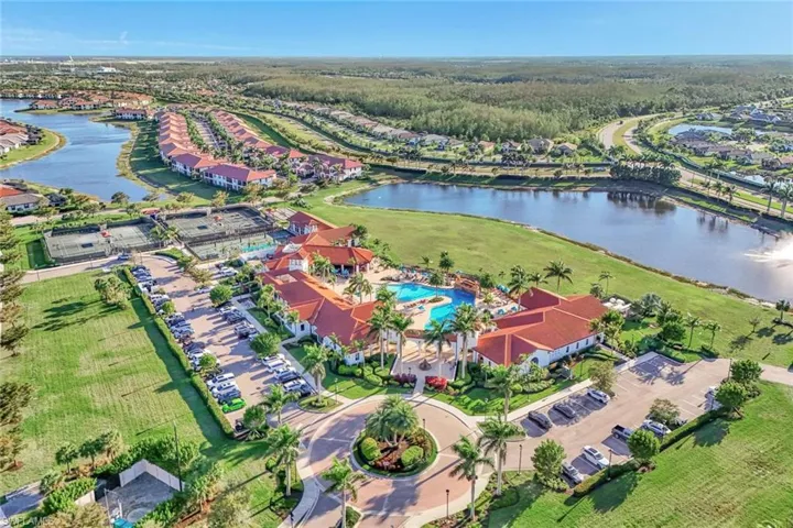 Aerial overview of property's location featuring a large body of water and a pool area