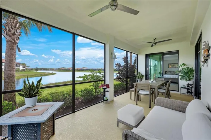 Sunroom / solarium with ceiling fan, a water view, and outdoor lounge area