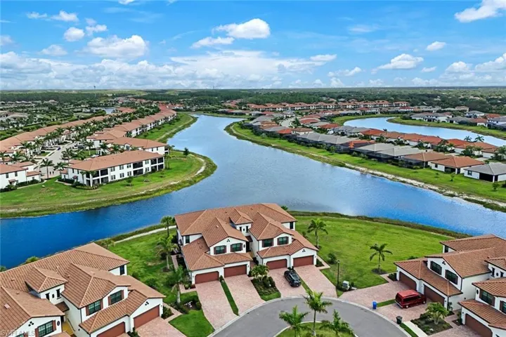 Aerial perspective of suburban area featuring a large body of water