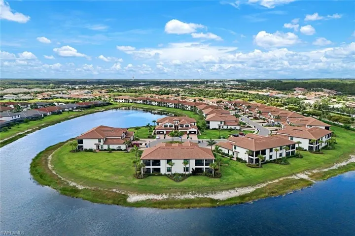 Aerial view of residential area featuring a large body of water