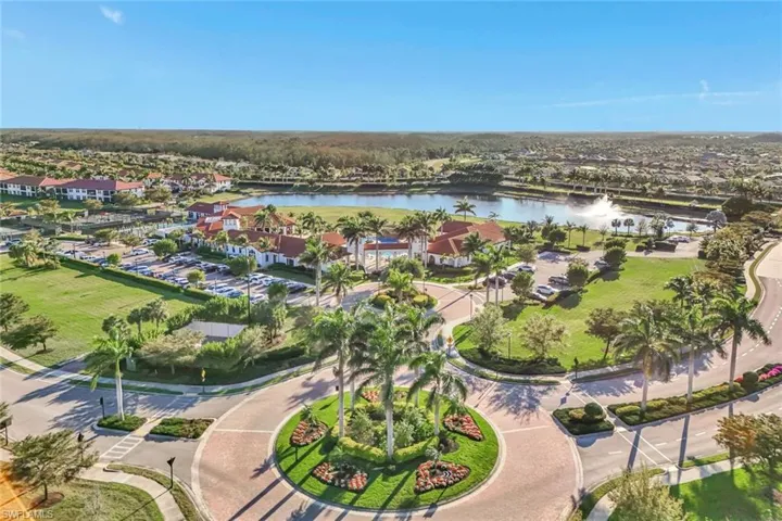 Aerial view of property's location featuring a large body of water and nearby suburban area