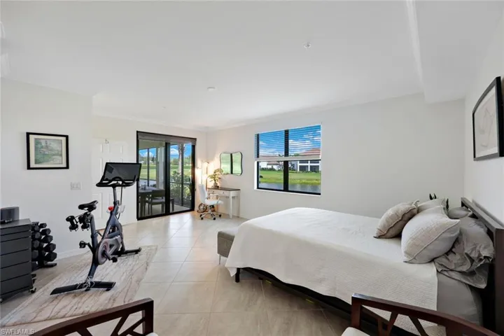 Bedroom with light tile patterned flooring and crown molding