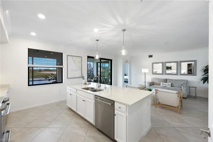 Kitchen featuring a sink, appliances with stainless steel finishes, white cabinetry, recessed lighting, and crown molding